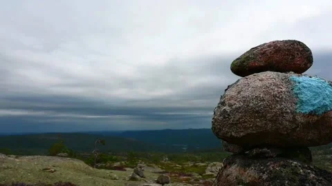 Stone stack marks trail in Norway's wilderness under cloudy sky in late aft.. Stock Footage 340213814