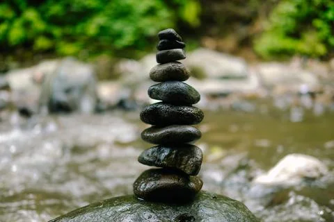 Stone Stack by River in Green Forest. Stock Photos