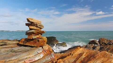 Stone stack stable and wave splash on background at Khao Laem Ya, Rayong, Thaila Stock Footage 105599396