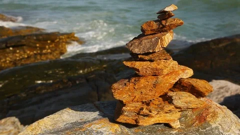 Stone stack stable and wave splash on background at Khao Laem Ya, Rayong, Thaila Stock Footage 105599550