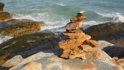 Stone stack stable and wave splash on background at Khao Laem Ya, Rayong, Thaila Stock Footage 105599560