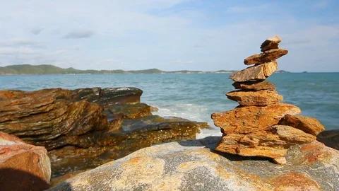 Stone stack stable and wave splash on background at Khao Laem Ya, Rayong, Thaila Stock Footage 105599795