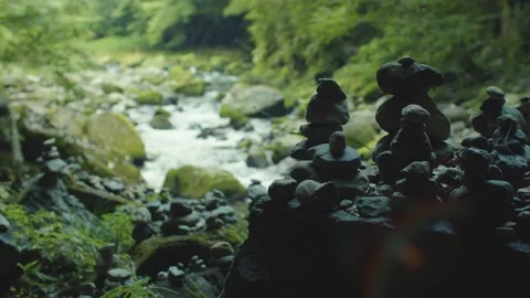 Stone stacking by a river in the forest Zen Japan 60 fps Stock Footage 234153037