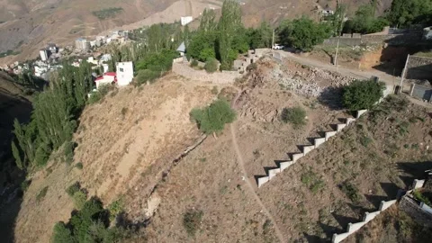 Stone stair wall on a Shem cliff edge stands among trees, masonry stepping Stock Footage 343804953