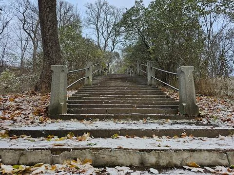 Stone staircase up covered with the first snow, no people, late autumn Stock Photos