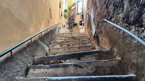 Stone Staircase Leading Down a Narrow Pathway with Rock Walls in Cinque Terre, I Stock Footage 283548168