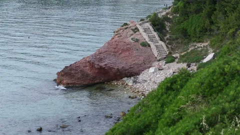 Stone staircase to wild beach at sunset Video stock 90531475