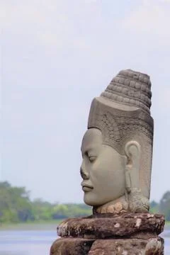 Stone statue of Deva at the south gate of Angkor Thom, Angkor Wat. Overlookin Stock Photos
