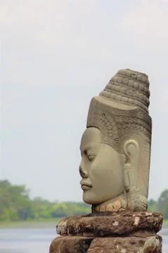 Stone statue Deva at the south gate of Angkor Thom, Angkor Wat. Overlooking t Stock Photos