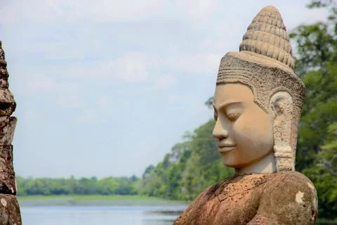Stone statue Deva at the south gate of Angkor Thom, Angkor Wat. Overlooking t Stock Photos