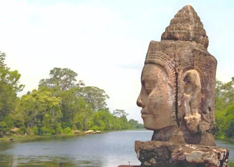 Stone statue Deva at the south gate of Angkor Thom, Angkor Wat. Overlooking t Stock Photos