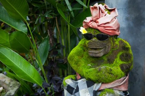 A stone statue of a monkey with glasses Stock Photos
