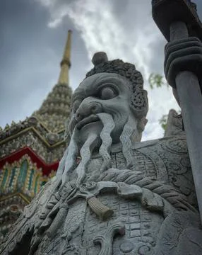 Stone statue of a mythological creature in front of temple Stock Photos