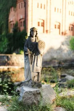 Stone statue with sword and shield on a stone Stock Photos