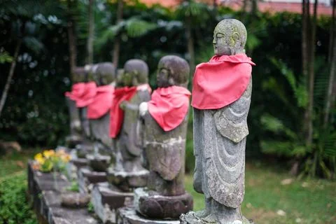Stone statues line a garden path Stock Photos