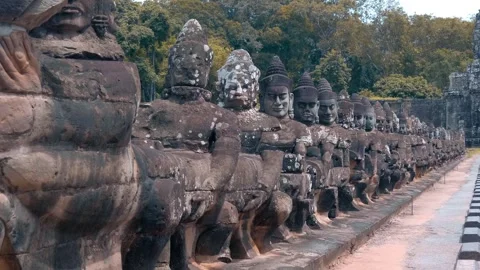 Stone statues lining the bridge road guarding entrance to Angkor Thom Stock Footage 318656454