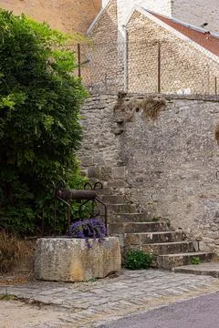 Stone steps and rustic masonry beside an old village building, Yonne, Montr.. Stock Photos