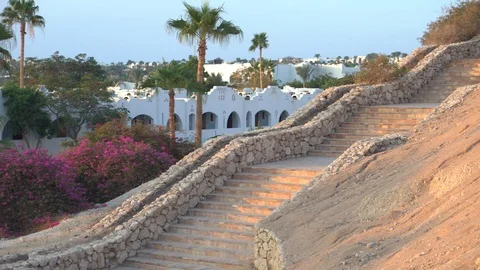 Stone steps on the background of white buildings and palm trees off the coast of Stock Footage 100839577