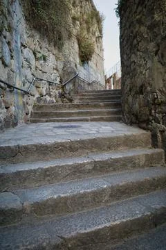 Stone steps climb a rugged cliffside. Stock Photos