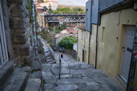 Stone steps descend steeply between aged buildings Stock Photos