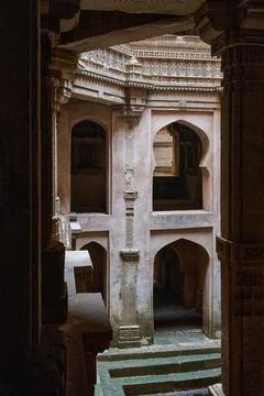 Stone steps descending into the multi-layered subterranean structure of the A Photos
