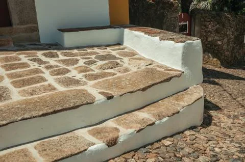 Stone steps on house facade with whitewashed wall Stock Photos