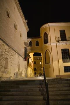 Stone steps lead upward beneath warm night lights Stock Photos
