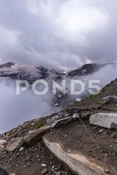 Stone steps with view of harsh landscape and glaciers in washington Stock Photos