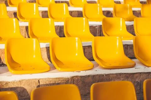 Stone steps with yellow plastic seats. Symbol of closed borders, empty hotels Stock Photos