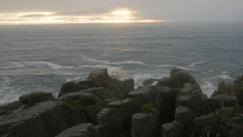Stone strata over the ocean at sunset, in New Zealand Stock Footage 219919972