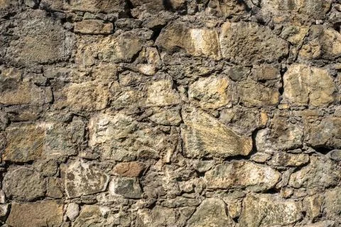 Stone structure of large and small stones in sunlight. Stock Photos