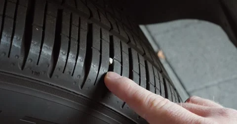 Stone stuck in tire tread close-up Stockbeeldmateriaal 333029954
