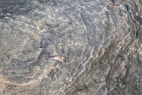 Stone surface with a beautiful circular pattern. Natural granite texture. Stock Photos