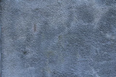 A stone surface with cracks, spots, irregularities. Stock Photos