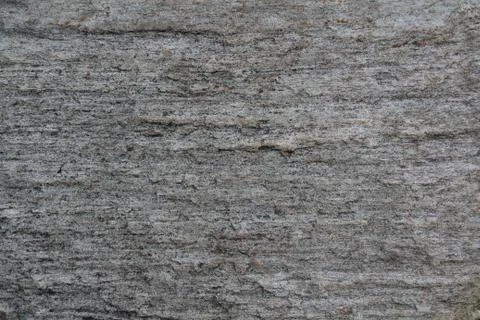 A stone surface with cracks, spots, irregularities. Stock Photos