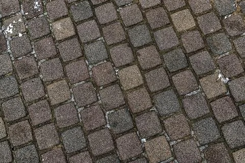 Stone surface old dark brown square cobblestone background Stock Photos