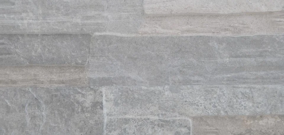 Stone surface texture on a wall with reliefs and shades of gray Stock Photos