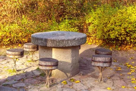 Stone table and log stools in the Park Stock Photos