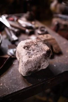 Stone on the table in the blacksmith's workshop Stock Photos