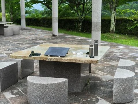 Stone table sits in quiet garden Stock Photos