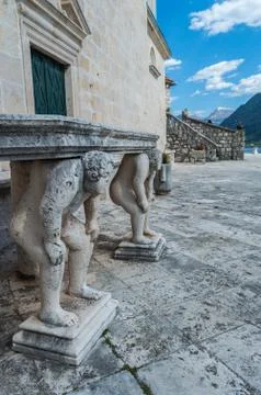 Stone table, which stands on two carved titans Stock Photos