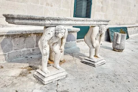 Stone table, which stands on two titans Stock Photos