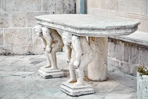 Stone table, which stands on two titans Stock Photos