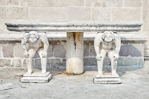 Stone table, which stands on two titans Stock Photos