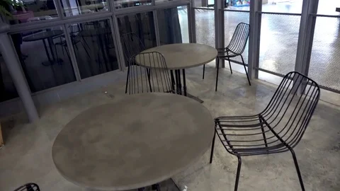 Stone tables and modern designer metal chairs Stock Footage 81941168
