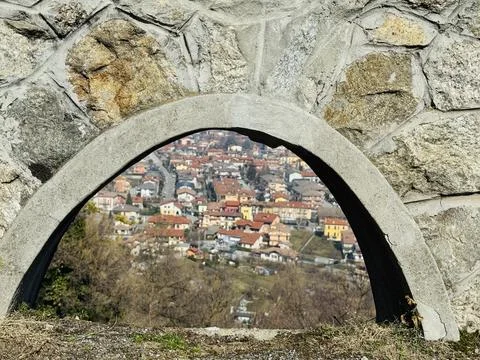 Stone terrace with arches overlooking rooftops of Italian town. Stock Photos
