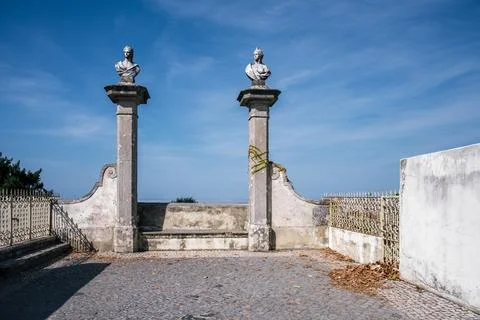 Stone terrace with two classical busts and blue sky in Sintra, Portugal Stock Photos