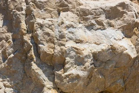 Stone texture background. Natural surface of the rock. Close-up. Stock Photos