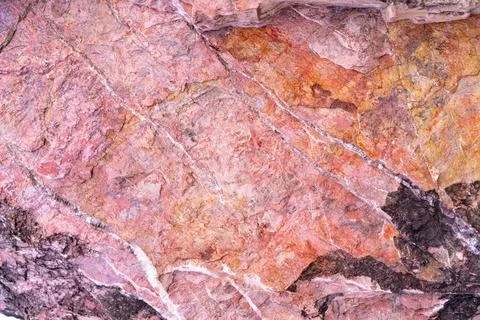 Stone texture background with unique pattern. Pink, red, black rock texture.. Stock Photos