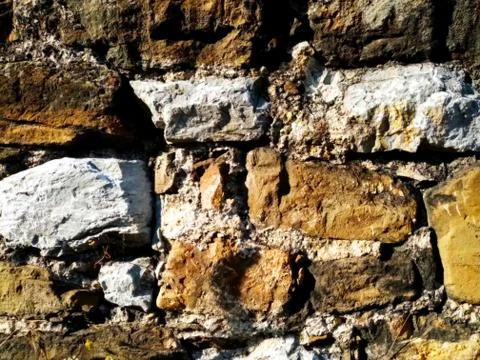 Stone texture of the facade of a very old house Stock Photos